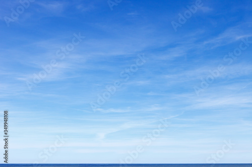 Beautiful blue sky with cirrus clouds over the sea. Skyline.