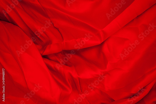 Close-up of folds of red fabric. Rolled up rag.