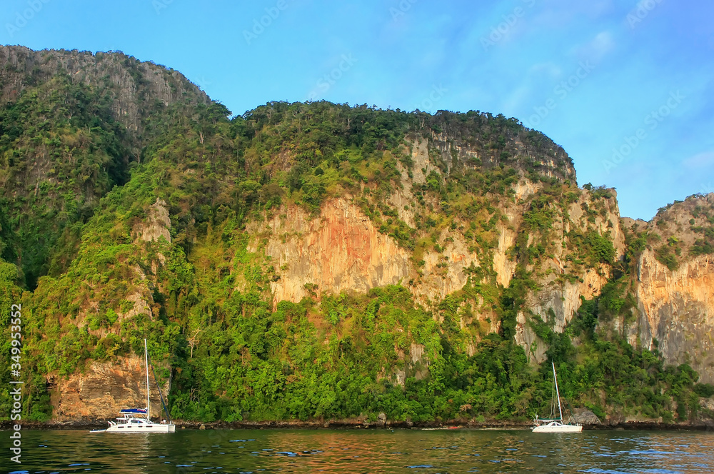 Obraz premium Ao Loh Dalum Bay surrounded by limestone formations on Phi Phi Don Island, Krabi Province, Thailand.