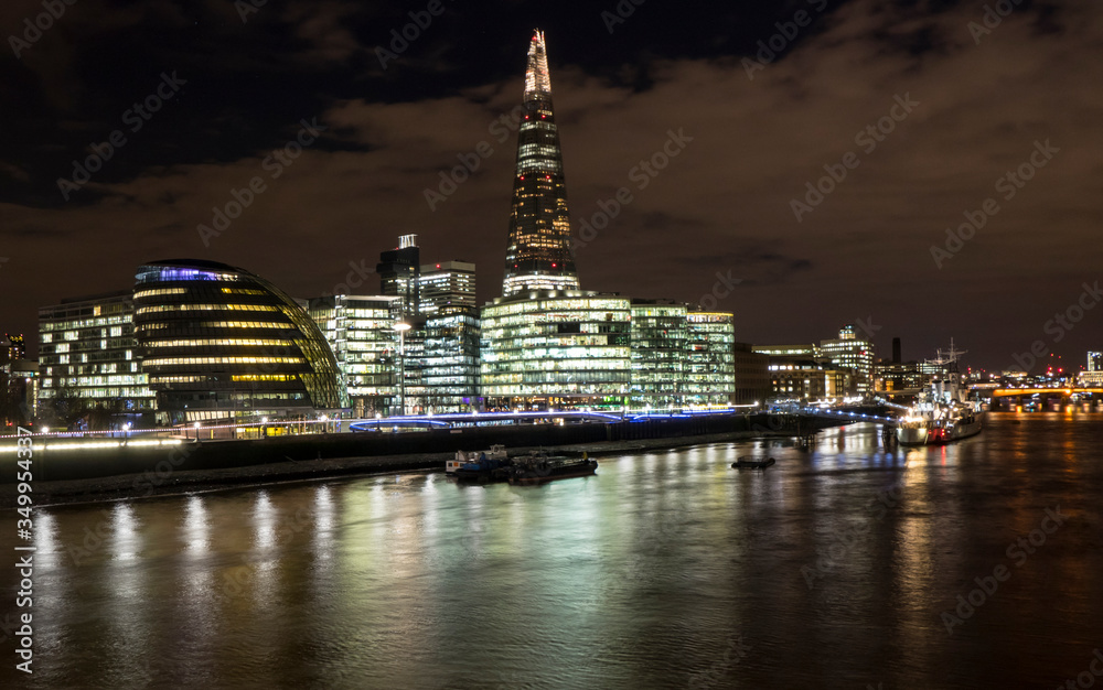 Skyline of London at night with skyscrapers illuminated in background