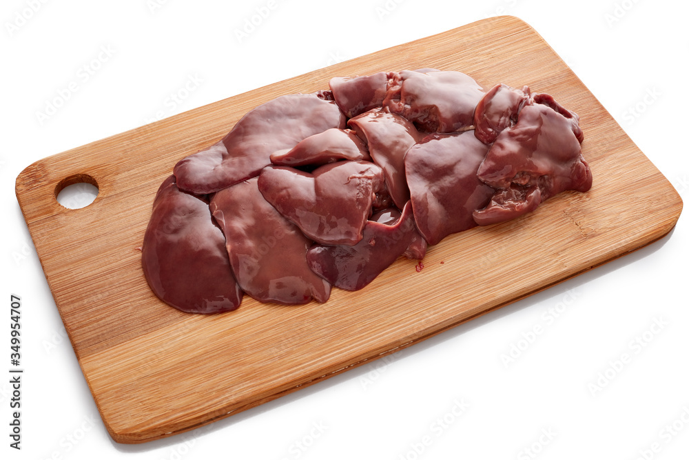 Raw chicken livers on on a wooden cutting board on white background. Raw chicken livers on on a wooden cutting board on white background.