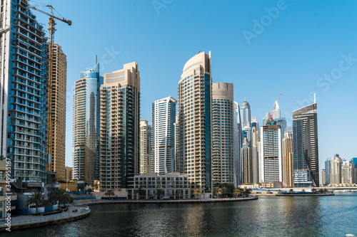 Panoramic view of Dubai skyscrapers in UAE. Dubai Marina prestigious residential area of Dubai close to the sea. Concept of financial success and luxury lifestyle.