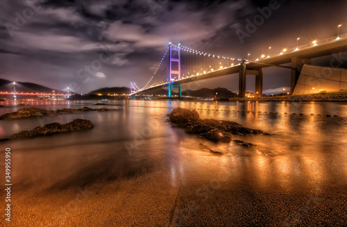 Ma Wan Island Suspension Bridge from the Beach at Night with Vibrant Reflections in the Water  Hong Kong