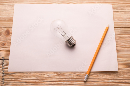 Light bulb looks like drawn in pencil on a white sheet of paper