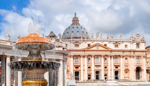 Fountain on St. Peter`s square and St. Peter's basilica, Vatican, center of Rome, Italy photo