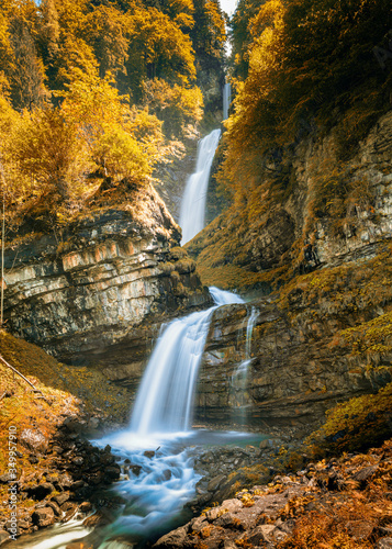 Fototapeta Naklejka Na Ścianę i Meble -  view of the idyllic Diesbach creek waterfall in the Swiss Alps near Braunwald and Glarus in the spring