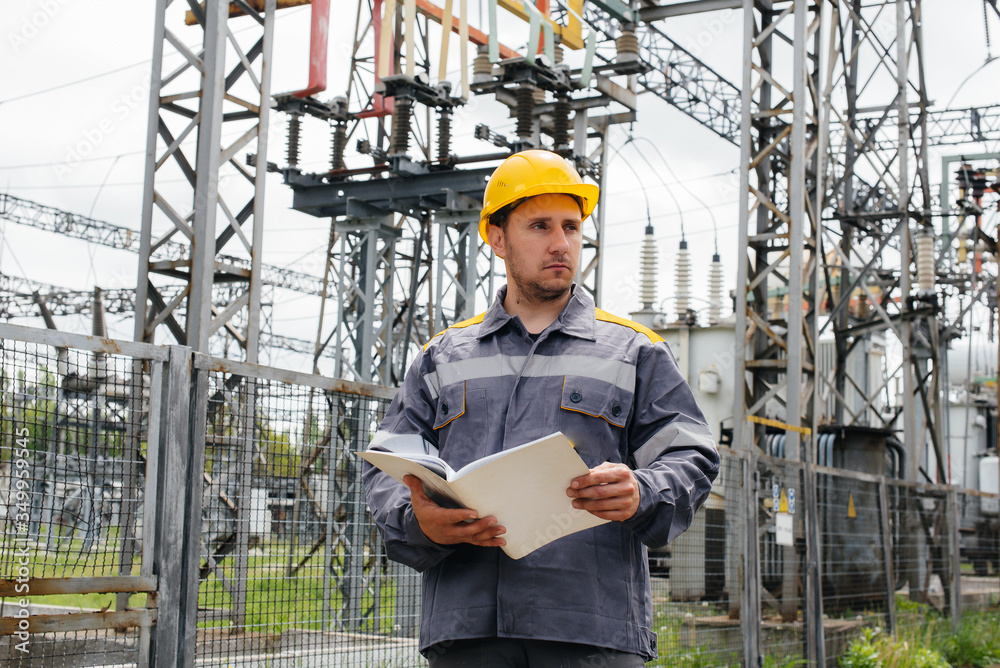 The energy engineer inspects the equipment of the substation. Power engineering. Industry The energy engineer inspects the equipment of the substation. Power engineering. Industry