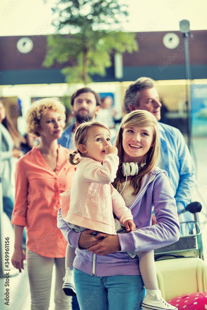 Fototapeta premium Family on holiday queueing for check in at airport 