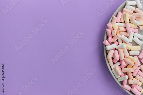 
Multicolored marshmallows. With copy space. On purple background. Top view.
