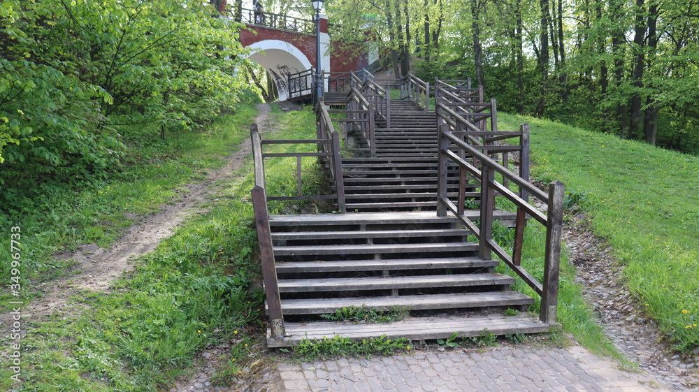 wooden stairs heading to park arch