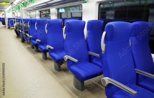 Blue seats in a high-speed train car.