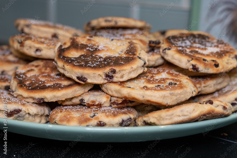 Stack of Homemade Welsh Cakes (Bakestones) freshly cooked on a green plate