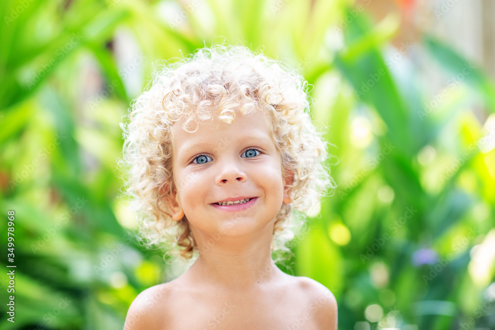 Portrait of a curly white boy in the park Portrait of a curly white boy in the park