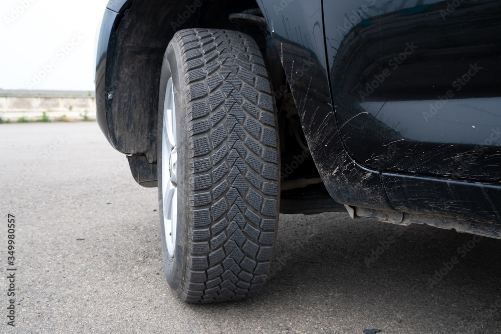 Car winter tire detail closeup, used car tires texture Car winter tire detail closeup, used car tires texture