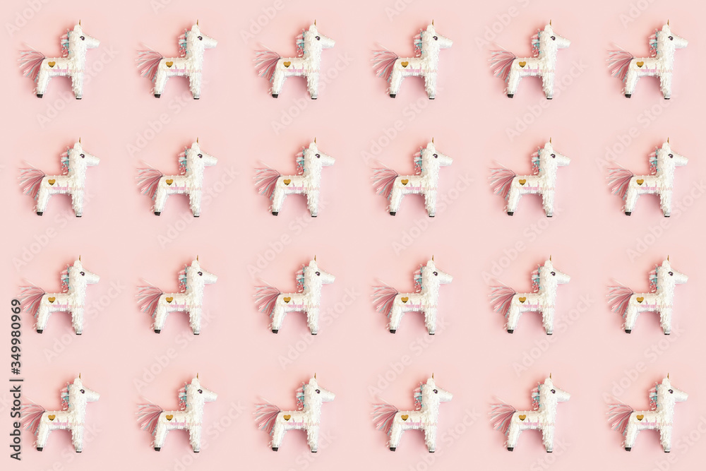 Fototapeta premium Birthday pinata unicorn pattern over pink background