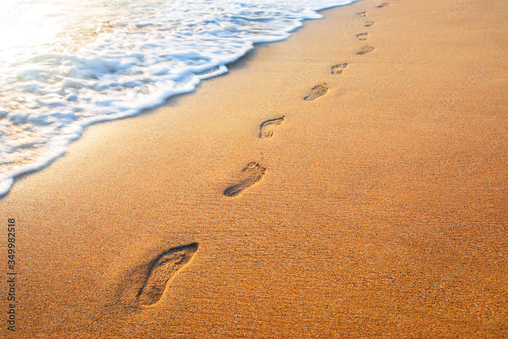 beach, wave and footprints at sunset time beach, wave and footprints at sunset time