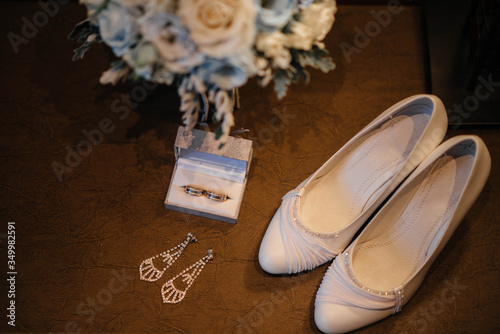 Wedding rings and other accessories close-up during the bride's gathering. Wedding
