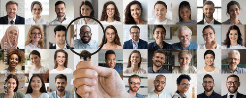 Male employer holding magnifier in hand finding unique talent african ethnic job candidate choosing among many lot of multiethnic people different faces collage. Recruiting, human resources concept.