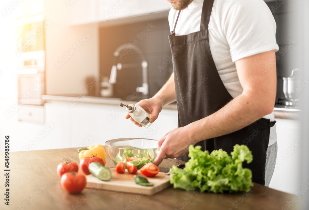 Young trendy man cooking healthy food in the morning Young trendy man cooking healthy food in the morning