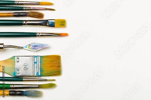 Billede på lærred Artistic art supply utensils with brushes on white background with copy space fl
