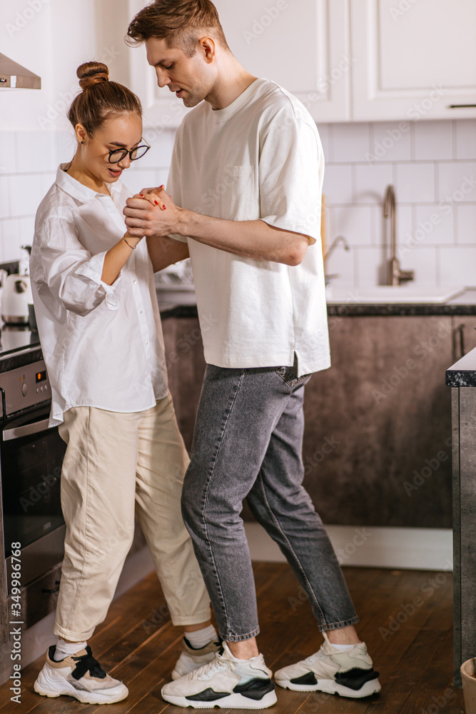 beautiful married couple dance in the kitchen at home, romantic happy time of young man and woman. caucasian couple love dancing in free time beautiful married couple dance in the kitchen at home, romantic happy time of young man and woman. caucasian couple love dancing in free time