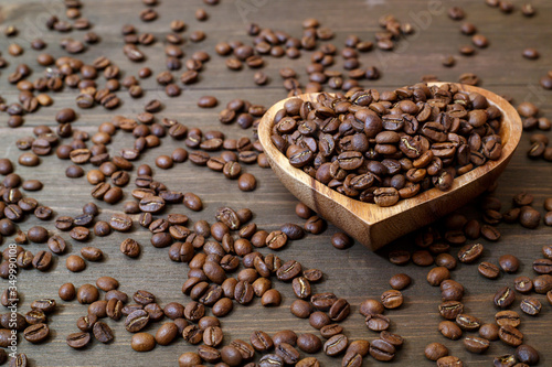 Aromatic roasted coffee beans in a wooden bowl
