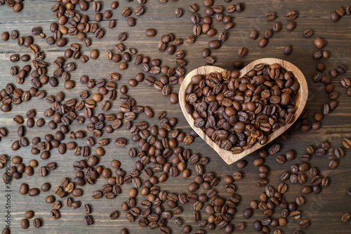 Aromatic roasted coffee beans in a wooden bowl