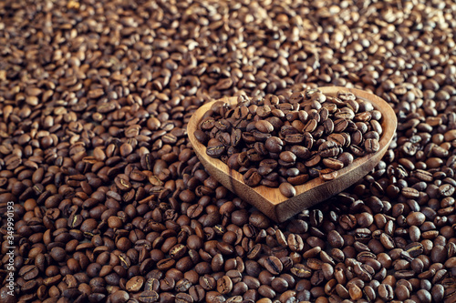 Aromatic roasted coffee beans in a wooden bowl