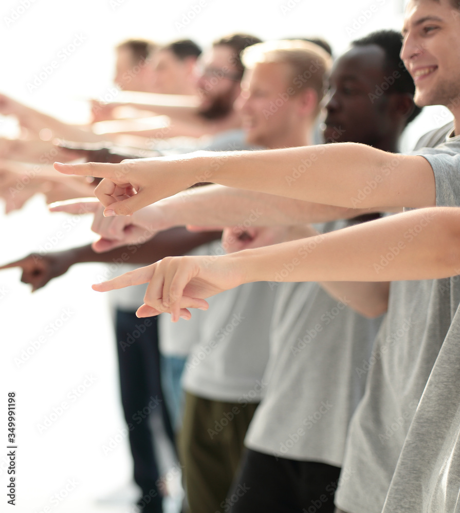 confident group of young men pointing ahead. confident group of young men pointing ahead.