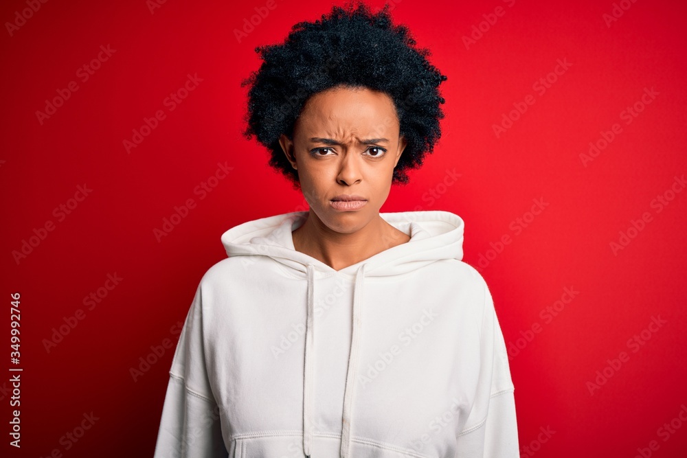Young beautiful African American afro sportswoman with curly hair wearing sportswear skeptic and nervous, frowning upset because of problem. Negative person.