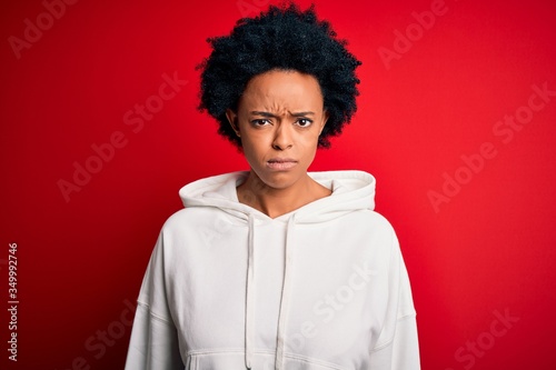 Young beautiful African American afro sportswoman with curly hair wearing sportswear skeptic and nervous, frowning upset because of problem. Negative person.