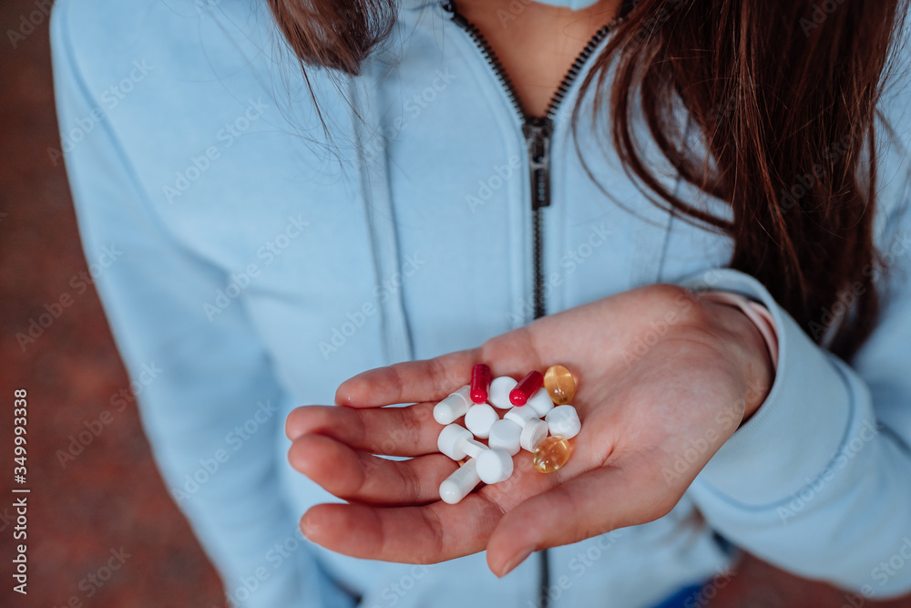 Coronavirus. Covid-19. A man or woman takes and shows pills. Coronavirus. Covid-19. A man or woman takes and shows pills.