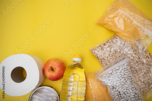 Photos Donations food with canned food on yellow background / canned goods and dry food