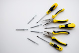 Yellow and black kit of working tools, pliers, wire cutters, dowel, screwdrivers as an idea for competition, winner, fight, aggressivity  plot