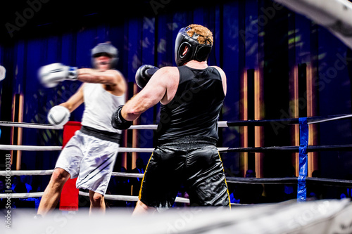 Amateur fight in a boxing ring, big swing photo