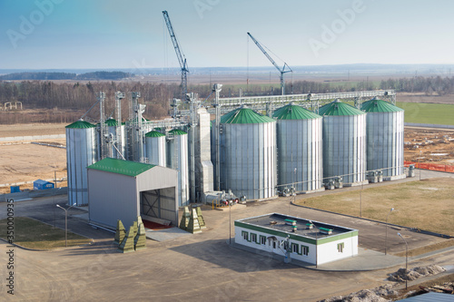 Construction of a feed mill agro-processing plant for processing and silos for drying cleaning and storage of agricultural products, flour, cereals and grain. Top view. photo