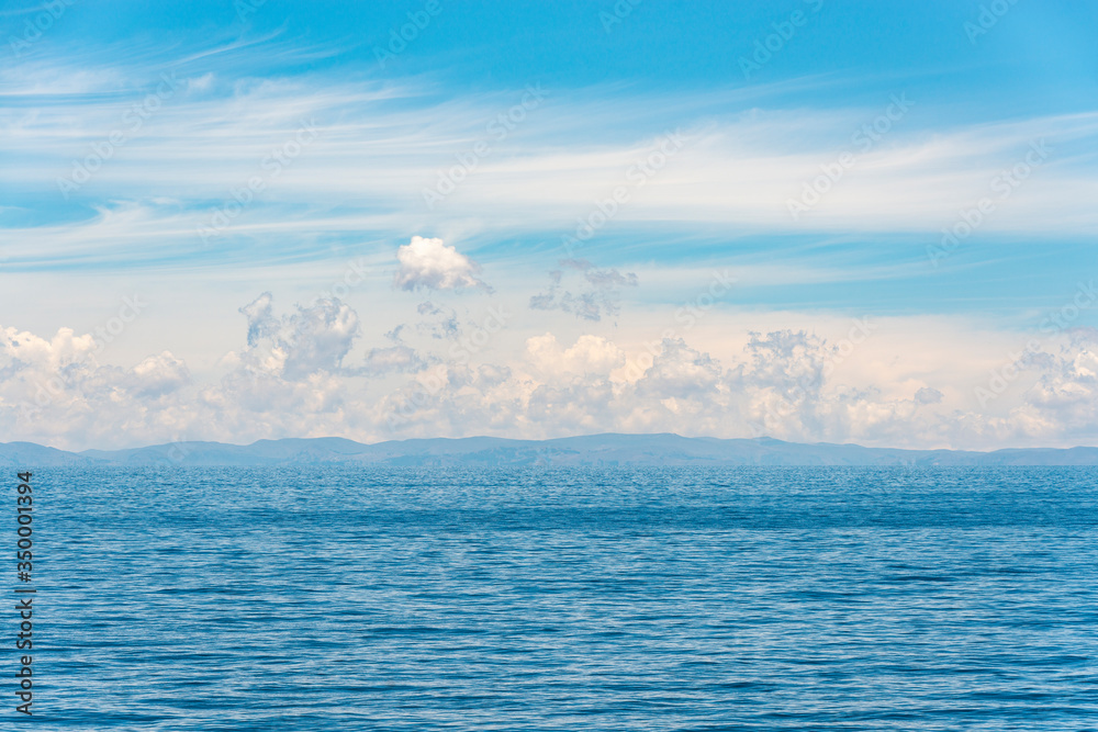 Blue waters landscape with Andes mountains in the horizon, Puno Region, Peru. Blue waters landscape with Andes mountains in the horizon, Puno Region, Peru.