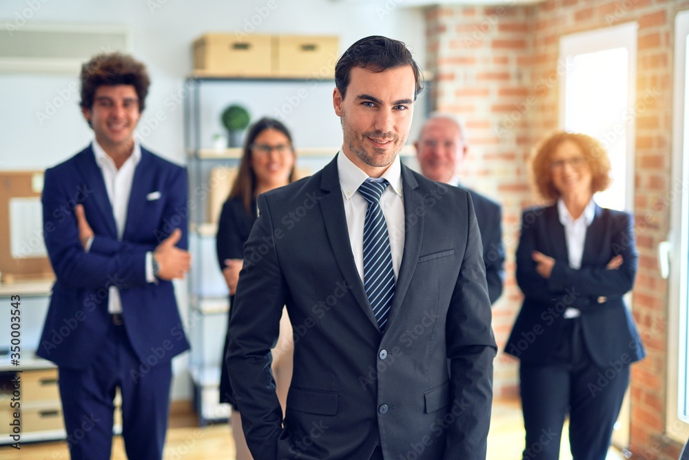 Group of business workers smiling happy and confident in a meeting. Standing with smile on face looking at camera at the office. Group of business workers smiling happy and confident in a meeting. Standing with smile on face looking at camera at the office.
