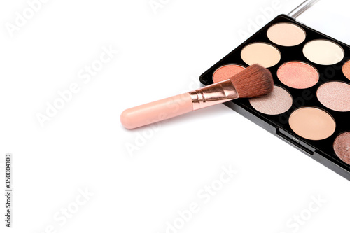 Make-up palette with brushes isolated on white background. top view