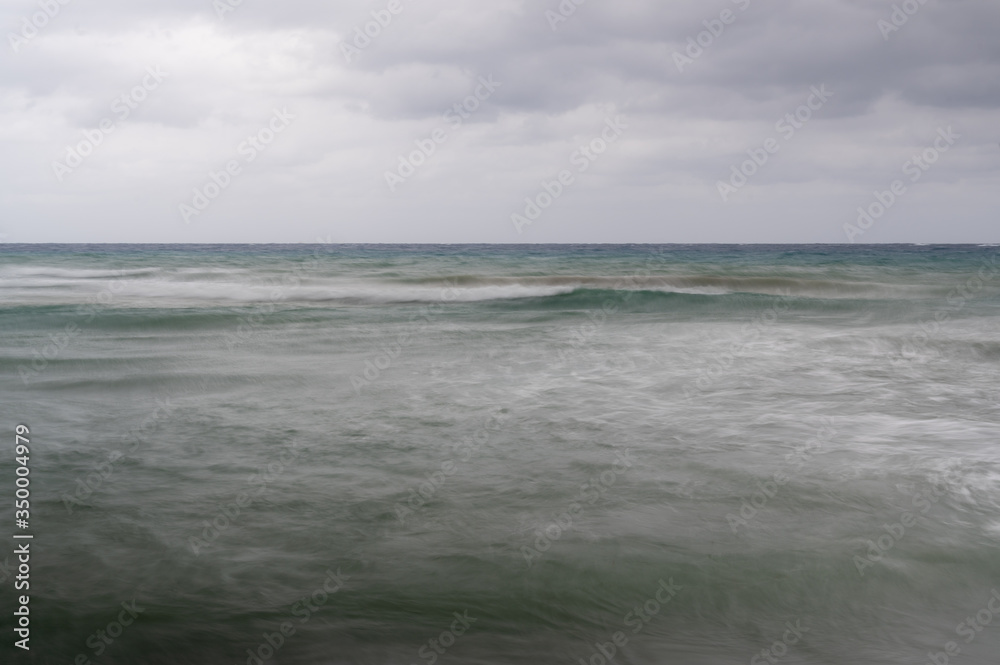 long exposure shot of the caribbean sea on a gray overcast day