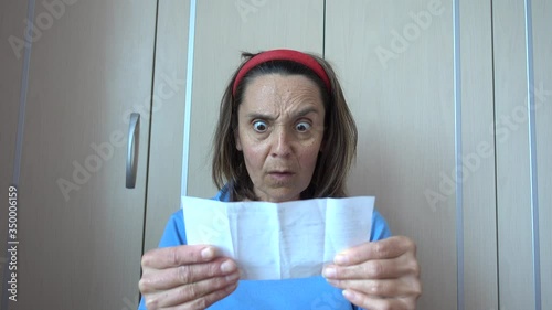 Fethiye, Turkey - 15th of May 2020: 4K At home woman gets outrage seeing a bill
