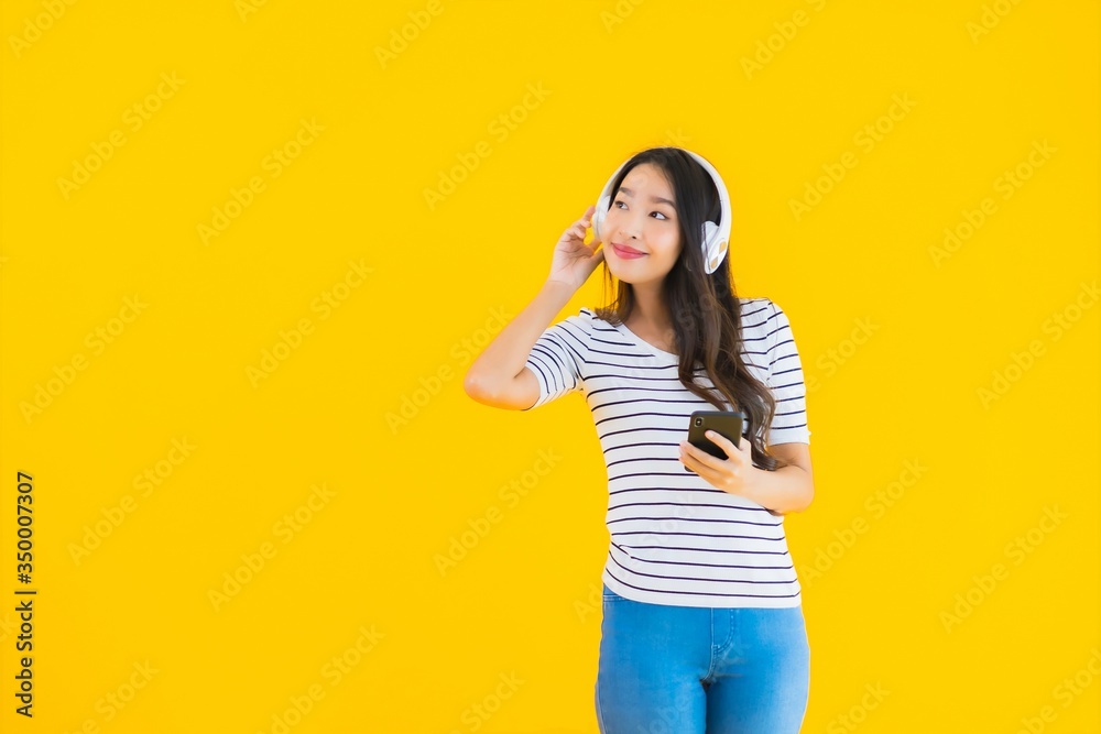 Portrait beautiful young asian woman use smart mobile phone with headphone Portrait beautiful young asian woman use smart mobile phone with headphone