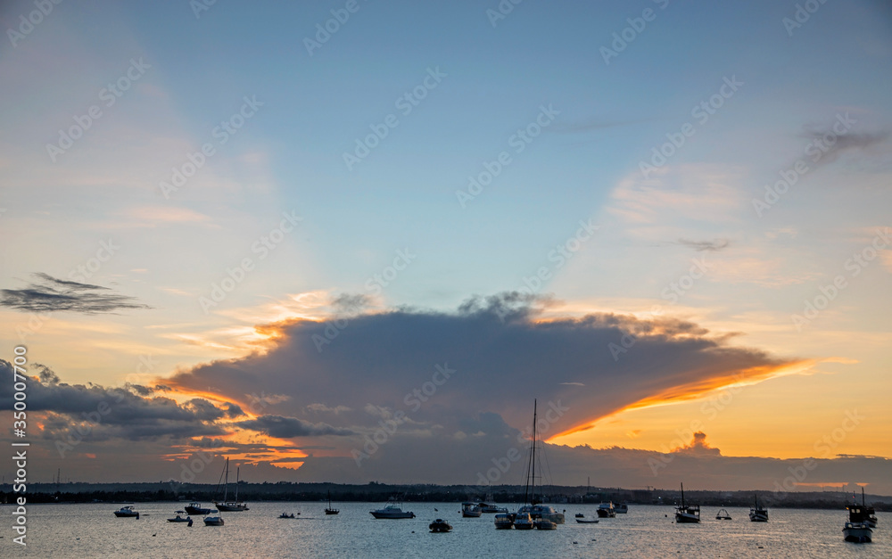 sunset with boats in the bay