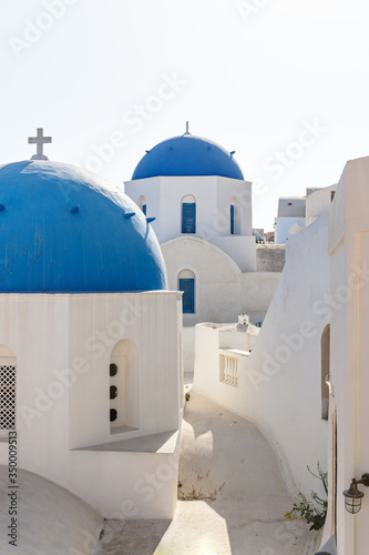 Path through two blue dome towers with crosses, Oia, Santorini, Greece