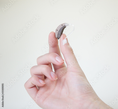 Very small hearing aid in female hands