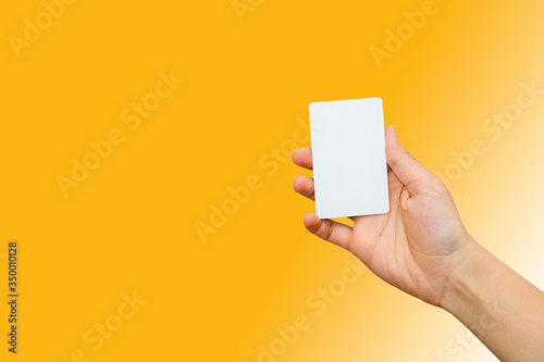 female hand holding bank card with colorful background
