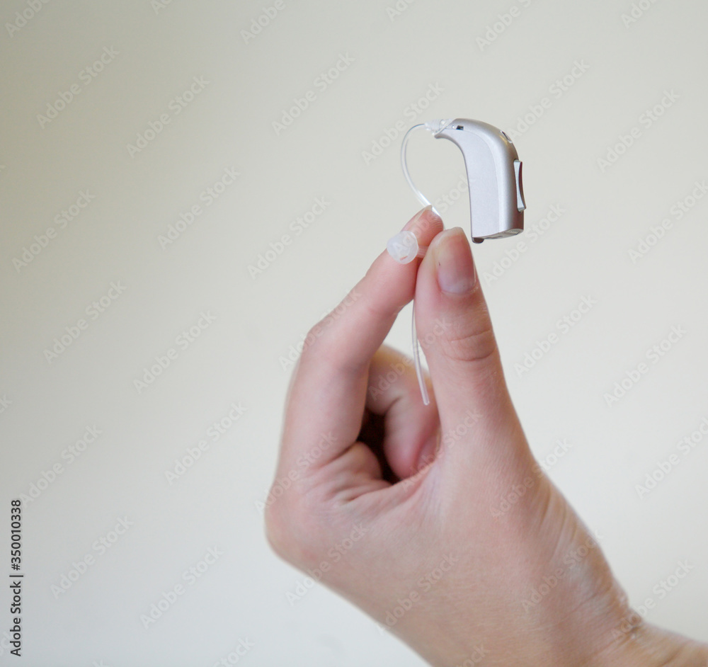 Very small hearing aid in a female hand