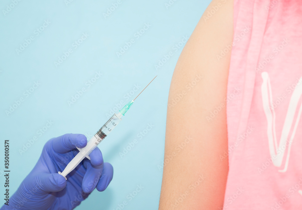 Doctor, nurse or scientist hand in blue nitrile gloves holding flu, measles, coronavirus vaccine shot for baby and adult vaccination, medicine and drug concept Doctor, nurse or scientist hand in blue nitrile gloves holding flu, measles, coronavirus vaccine shot for baby and adult vaccination, medicine and drug concept