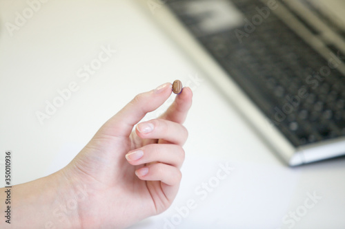 Very small hearing aid in a female hand
