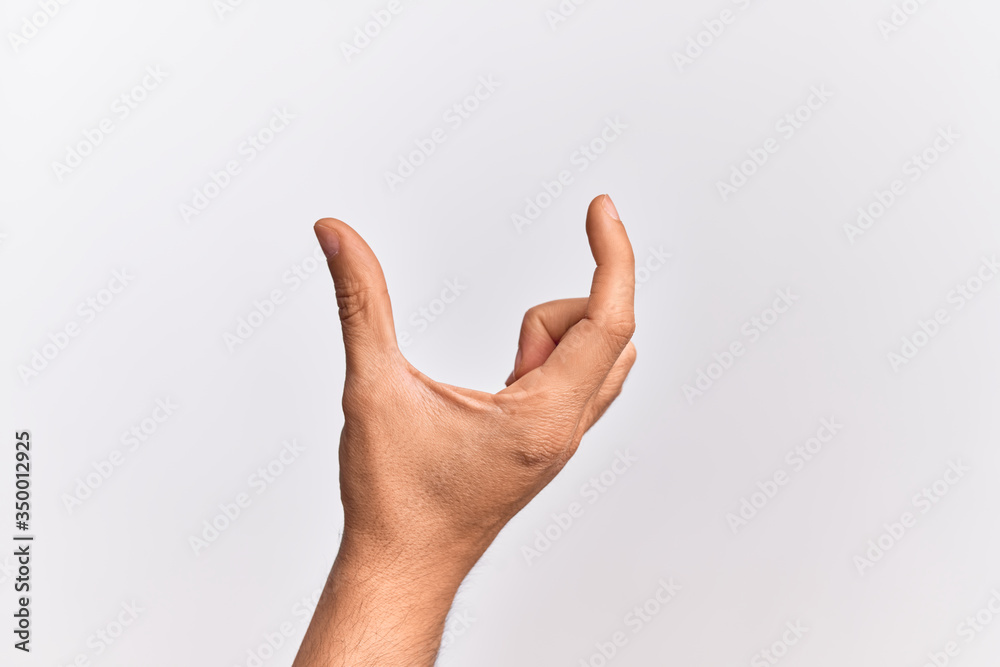 Hand of caucasian young man showing fingers over isolated white background picking and taking invisible thing, holding object with fingers showing space Hand of caucasian young man showing fingers over isolated white background picking and taking invisible thing, holding object with fingers showing space